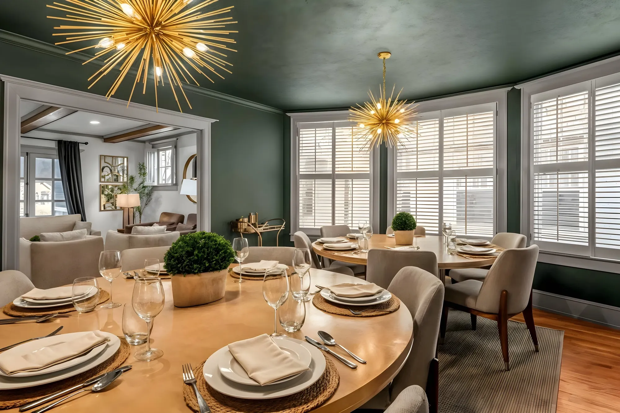 Adair dining room with a round table set for six, green walls, and a starburst fixture